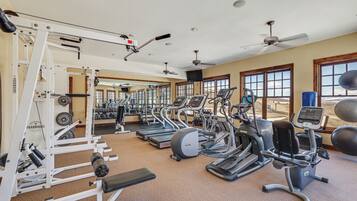 A gym with treadmills, elliptical machines, and weight equipment.