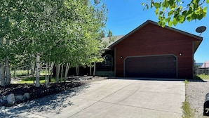 A residential garage with a clear driveway and a satellite dish on the roof.