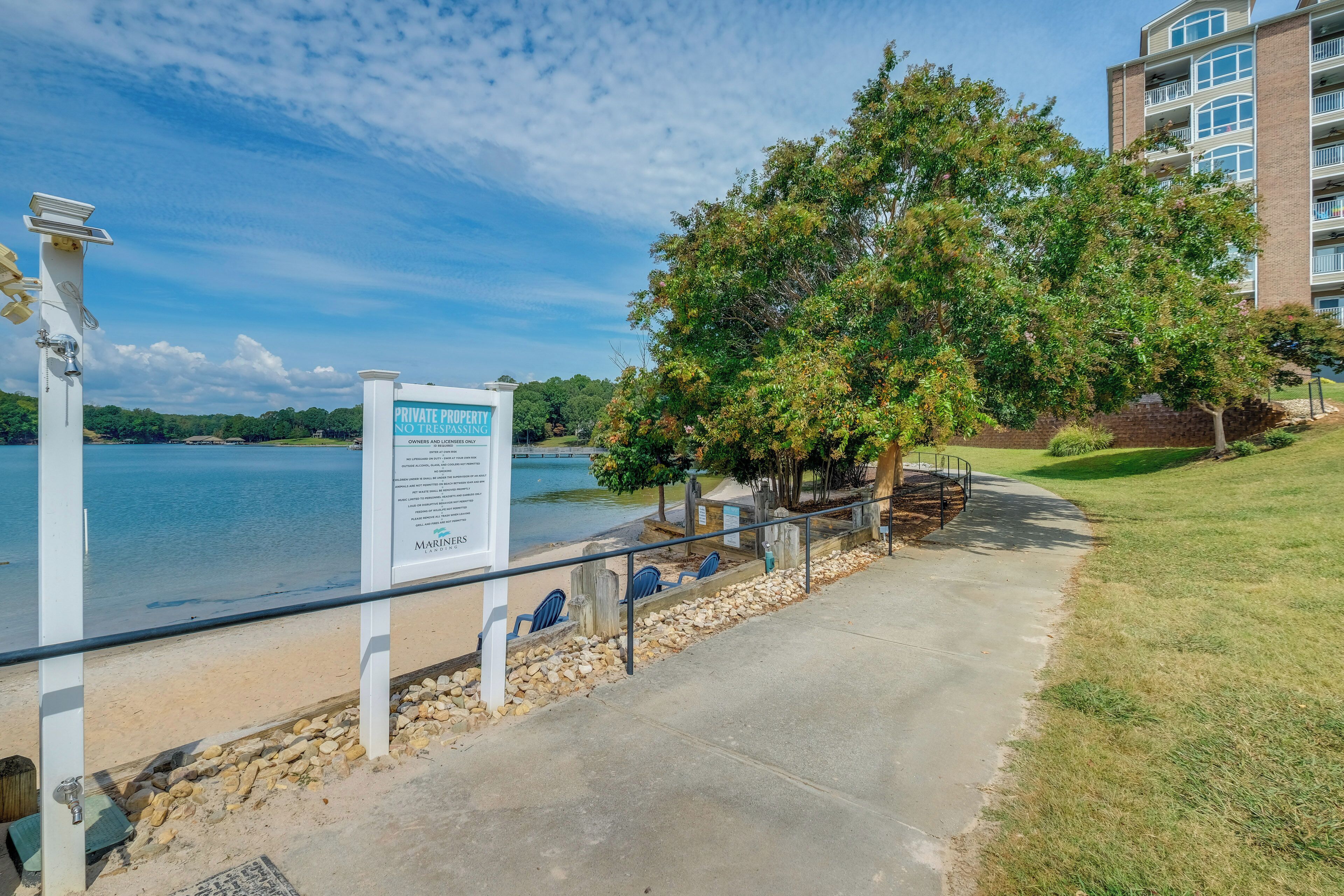 A waterfront property with a private beach, a sign indicating no trespassing, and a marina.