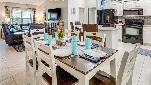 A modern kitchen with a refrigerator, microwave, and stove. - Golf, Shop & Unwind: Home w/ Patio in The Villages (The Villages)