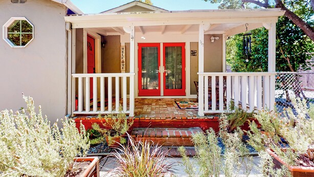 A house with a red door, white porch, and a welcome sign. - Centrally Located! Dog-friendly San Rafael Home (San Rafael)