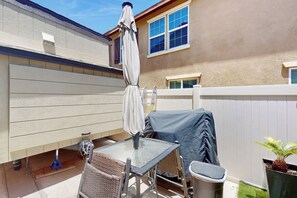 A patio with a table, chairs, a covered grill, and a potted plant. - Pool & Hot Tub Access: Cozy Perris Tiny Home (Perris)
