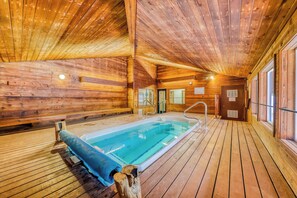 A wooden cabin interior with a pool, wooden floors, and large windows. - Giant Steps #38 Condo in Brian Head (Brian Head)