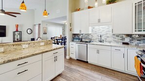 A modern kitchen with white cabinets, a granite countertop, and a backsplash. - Dog-friendly Family Home w/ Patio & Fire Pit! (Richmond Hill)