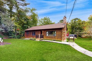 A log cabin with a porch, a chimney, and a small deck. - 4-season Family Base! 13 Mi to Lake Winnipesaukee (Center Barnstead)