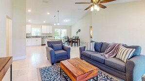 A spacious living room with a sofa, armchairs, and a coffee table. A ceiling fan and recessed lighting are visible. - A Place in the Sun: Close to Shops & Attractions (Ocala)