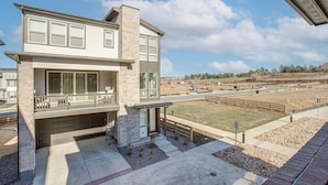A modern two-story house with a garage, a balcony, and a well-maintained lawn. - 8 Mi to Denver Tech Center: Business-ready Retreat (Centennial)