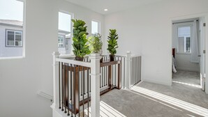 A spacious room with a high ceiling, large windows, and a wooden railing with potted plants. - 8 Mi to Denver Tech Center: Business-ready Retreat (Centennial)