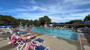 A swimming pool area with lounge chairs and umbrellas. - Pool & Beach Access! 'lake Arrowhead Hideaway' (Nekoosa)