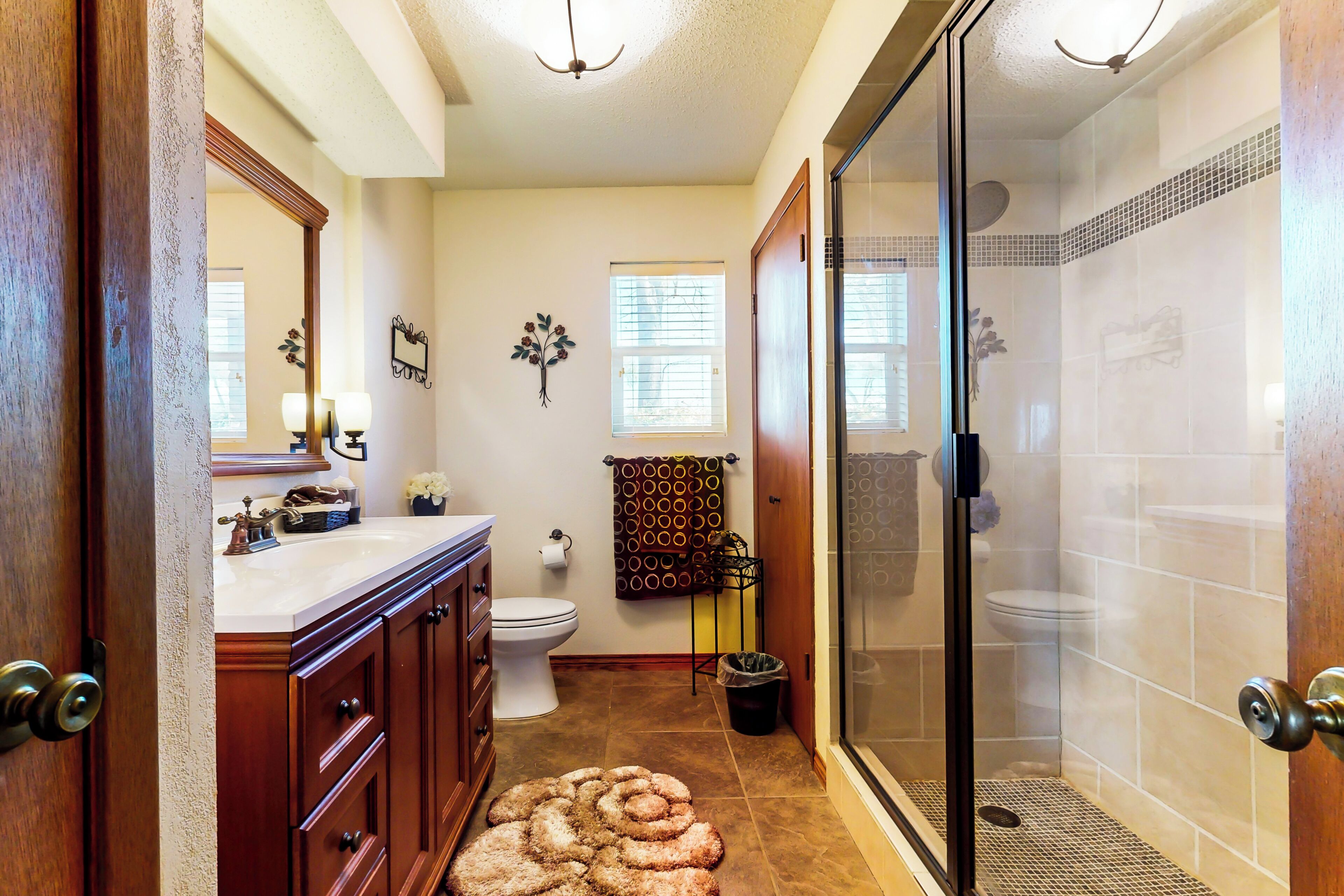 A bathroom with a shower, toilet, and vanity.