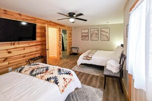 A hotel room with two beds, a ceiling fan, a TV, and artwork on the wall. - Bowling Alley! Expansive Group Getaway in Lewiston (Lewiston)