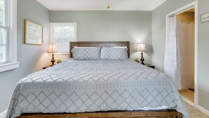 A bedroom with a bed, two bedside lamps, a ceiling fan, and a window. - 2BR Lakefront Getaway w/ Dock & Boat Launch (Bonneau)
