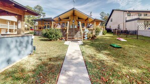 A residential property with a covered porch, a wooden deck, and a concrete pathway leading to the entrance. - 'harbor Haven' w/ Dock: Lake Livingston Home (Livingston)