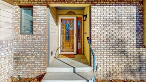 A brick exterior with a wooden door and a small window. - Lake-view, Dog-friendly 5BR w/ Fireplaces, Deck (Greeley)