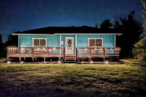 A two-story house with a porch, a front door, and a small front yard. - Countryside Charmer w/ Fire Pit in Washington! (Washington)