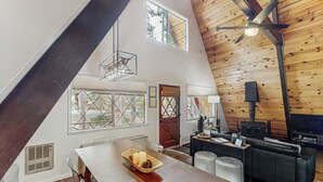 A modern interior with a dining area, a sofa, and a fireplace. - Fire Pit! A-frame Escape, 33 Mi to Sunrise Park (Pinetop)