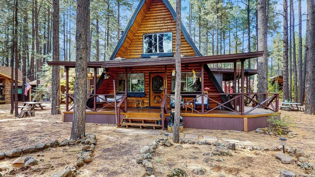 A cabin with a triangular roof, wooden deck, and a porch with benches. - Fire Pit! A-frame Escape, 33 Mi to Sunrise Park (Pinetop)