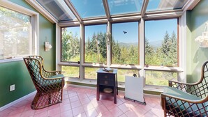 A room with a large skylight, two wicker chairs, a small table, and a whiteboard. - 100 Yards to Foster Lake! Family Home w/ Hot Tub (Foster)