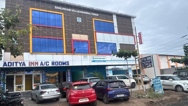 A building with signage for 'Sivalingam Vellachiammal Tower' and 'Aditya Inn A/C Rooms'. - Aditya Inn (Krishnagiri)