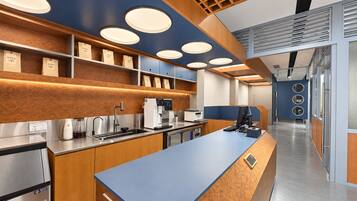 A modern kitchen with a central island, stainless steel appliances, and wooden cabinetry.