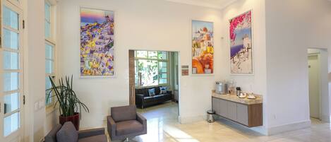 A spacious living area with a sofa, a coffee table, and a potted plant.