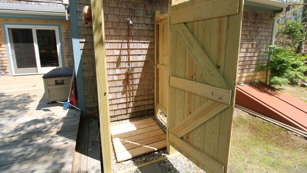 A wooden structure with a door, a window, and a small step leading to a raised platform. - Private Orleans Getaway Near Bakers Pond & Beaches (2422) (Orleans)