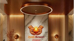 A reception desk with a marble top and wooden paneling, featuring the logo 'Jyoti Resort Joypur'. - JYOTI RESORT JOYPUR (Bishnupur)