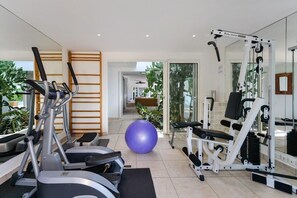 A home gym with exercise equipment, a large exercise ball, and a mirror. - Encore   Tropical Gardens and Ocean Views (Saint Martin)