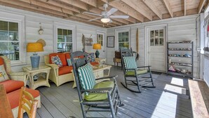 A covered porch with wicker furniture, a ceiling fan, and a shelf with items. - 4 Bedroom 2 Bath Inlet Front Home with Deep Water Access (Murrells Inlet)