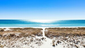 A beach with sand dunes and a clear blue sky. - Coastal Luxury | Beachfront Home | Lagoon Views (Gulf Shores)