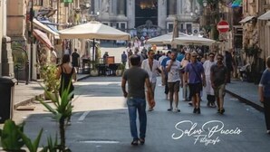 A street leading to a grand building with a dome and statues. - B&B Piazza Mazzini (Catania)