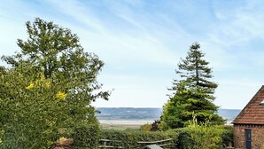A rural landscape with a stone building, a wooden fence, and a view of the countryside. - 1 bedroom accommodation in Lydney, Forest of dean (Lydney, Forest of dean)