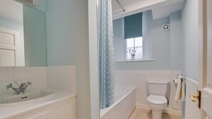 Une salle de bain avec une baignoire, des toilettes et un lavabo.