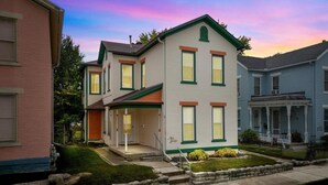 A two-story residential building with a porch, a small front yard, and a brick driveway. - Historic south park gem - close to UD, MVH & more. (Dayton)