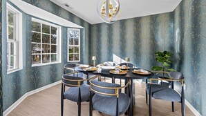 A dining room with a round table, six chairs, and a chandelier. - Spacious Raleigh Retreat | 5BR, Near Village District, NCSU & Downtown (Raleigh)