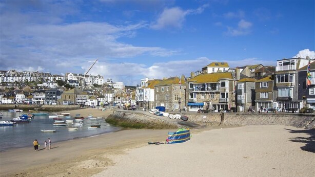 A coastal town with buildings along the shore, a sandy beach, and several boats in the water. - 1 Bed in St Ives (oc-lhse) (St Ives)