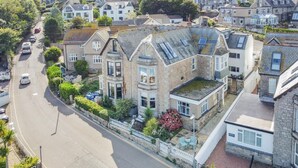 A stone building with a prominent bay window, a small garden, and a street view. - 2 Bed in St Ives (oc-trev2) (Saint Ives)