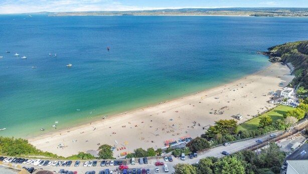 An aerial view of a beach with a parking lot and a road leading to the beach. - 2 Bed in St Ives (oc-trev2) (Saint Ives)