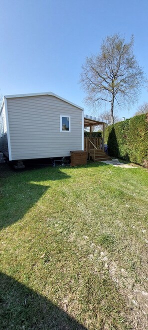 A mobile home with a covered porch and a small window. - Salsa Confort (Les Mathes)