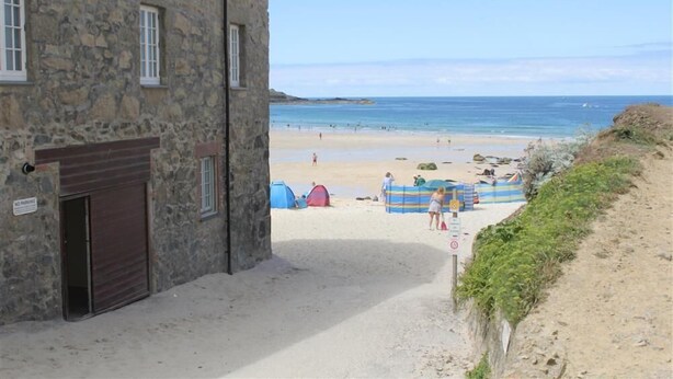 A stone building with a closed door and a 'No Parking' sign. - 1 Bed in St Ives (oc-salt3) (Saint Ives)