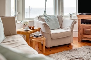 A cozy living room with a sofa, a coffee table, and a television. - 3 Bed in St. Ives (oc-chan15) (St Ives)