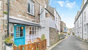 A narrow street lined with stone buildings, a wooden fence, and a blue door. - 2 Bed in St Ives (oc-killa) (St Ives)