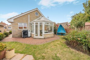 A residential property with a brick exterior, a conservatory, and a garden. - 2 Bed in Staithes (oc-wa071) (Staithes)