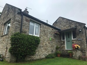 A stone building with a green door, a window with a white frame, and a sign that reads "WATERCRAG". - 2 Bed in Gunnerside (oc-ds945) (Gunnerside)