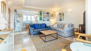 A modern living room with a sofa, a coffee table, and a fireplace. - 3 Bed in Southwold (oc-hshore) (Southwold)
