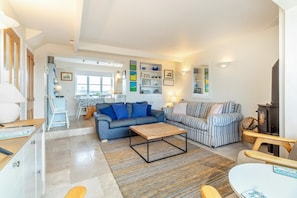 A modern living room with a sofa, a coffee table, and a fireplace. - 3 Bed in Southwold (oc-hshore) (Southwold)