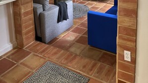 Una sala de estar con televisor, sofás y chimenea.