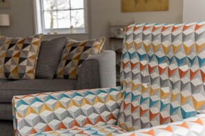 A living room with a sofa and armchairs featuring geometric patterned upholstery. - 6 Bed in Nr Southwold (oc-hohall) (Reydon)
