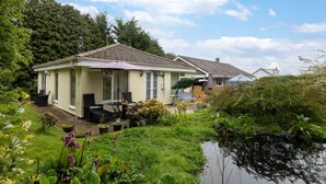 A house with a patio, outdoor seating, and a pond. - 1 Bed in Belford (oc-nb677) (Belford)
