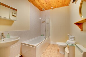 A bathroom with a bathtub, a toilet, and a sink.
